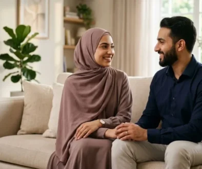 can wife refuse husband in bed islam, a couple sitting in the sofa hold their hand.