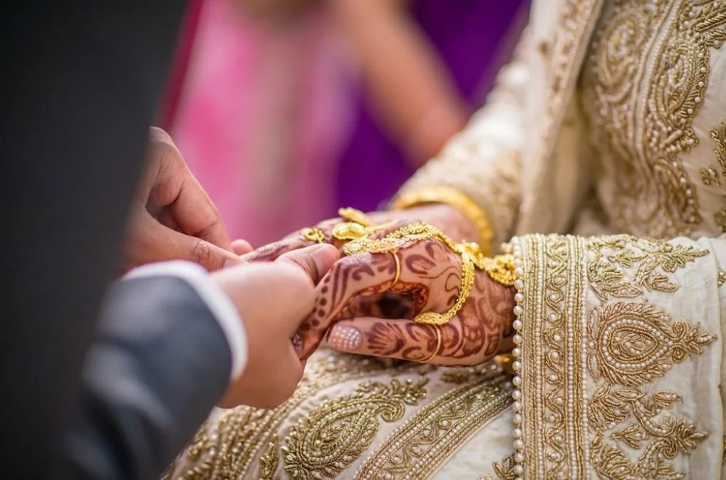 find a good Muslim husband, Close-up of a Muslim groom placing a gold marriage ring on his bride's finger during a traditional Nikkah ceremony.