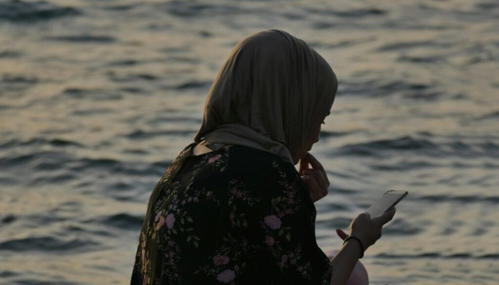 Salams app alternative UK - Muslim woman comparing halal marriage apps on her phone