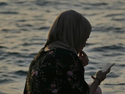 Salams app alternative UK - Muslim woman comparing halal marriage apps on her phone