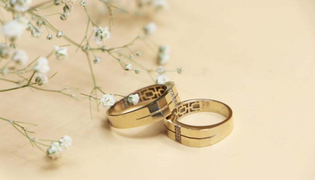 Gold and silver wedding bands on a white surface, representing mahr in Islam