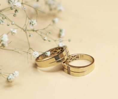 Gold and silver wedding bands on a white surface, representing mahr in Islam