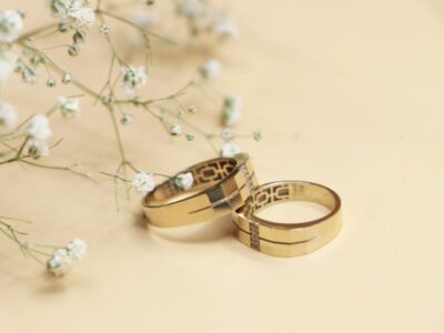 Gold and silver wedding bands on a white surface, representing mahr in Islam